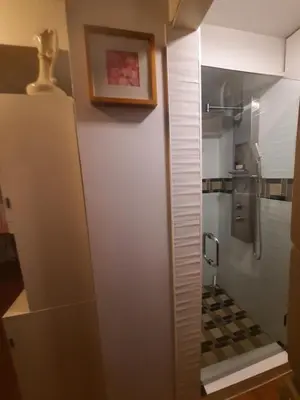 a bathroom with a shower with a glass door at Simply Suite - Sua Casa Longe de Casa in YYJ