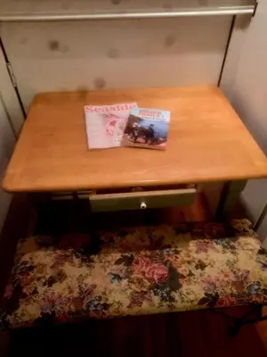a wooden table with a book on top of a bench at Simply Suite - Sua Casa Longe de Casa in YYJ