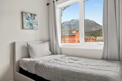 a bedroom with a bed and a large window at Radiant Retreat -Spacious Home - Heart of Radium! in Radium Hot Springs