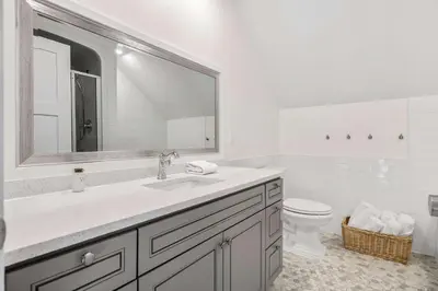 a white bathroom with a sink and a toilet at Radiant Retreat -Spacious Home - Heart of Radium! in Radium Hot Springs