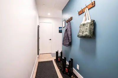 a hallway with a blue wall and a door at Alpenstoke in Revelstoke