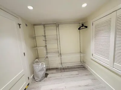 a room with shelves and a window at Quiet Basement Suite Steps from Quilchena Park in Vancouver in Vancouver