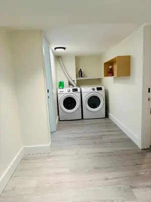 a laundry room with a washer and dryer in it at Quiet Basement Suite Steps from Quilchena Park in Vancouver in Vancouver