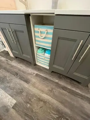 a kitchen cabinet with drawers with towels in it at Passage view in Campbell River
