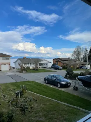 a car parked in the driveway of a house at Passage view in Campbell River