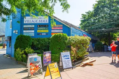 a blue building with signs in front of it at 2 Bedroom with Lake and Mtn Views in Harrison Hot Springs