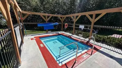 a swimming pool with a wooden structure with at Purcell Condos by StayIn in Kimberley