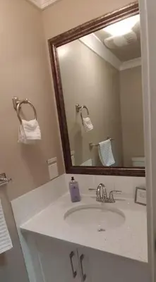 a bathroom with a sink and a large mirror at Burnaby 4 bed 3 bath duplex in Burnaby