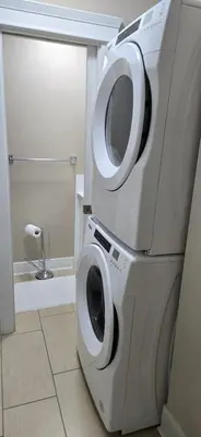 a washer and dryer in a bathroom at Burnaby 4 bed 3 bath duplex in Burnaby