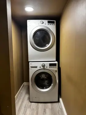 a washer and dryer in a small room at Cozy and Spacious Basement in Chestermere