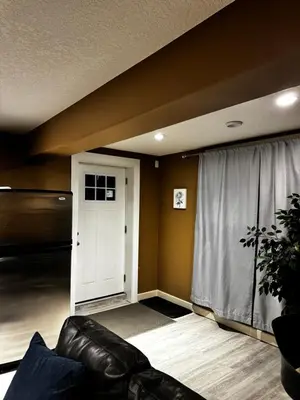 a living room with a couch and a window at Cozy and Spacious Basement in Chestermere