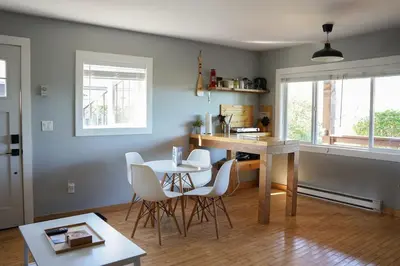 a kitchen with a table and chairs in a room at Coastal Suite - Harbourview in Ucluelet in Ucluelet