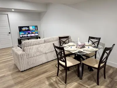 a living room with a table and a couch at Charming Basement Suite in Edmonton