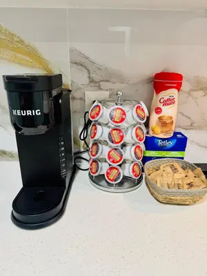 a coffee maker next to a tray of cupcakes at Charming Basement Suite in Edmonton