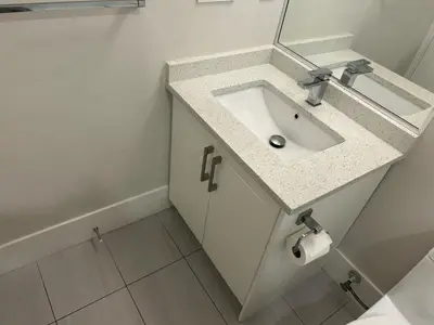 a bathroom with a sink and a mirror at Spacious one Bedroom Suite Right in Downtown ! in Maple Ridge District Municipality