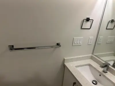 a bathroom with a sink and a mirror at Spacious one Bedroom Suite Right in Downtown ! in Maple Ridge District Municipality