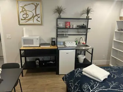 a room with a desk with a computer and a deskictericter at Spacious one Bedroom Suite Right in Downtown ! in Maple Ridge District Municipality