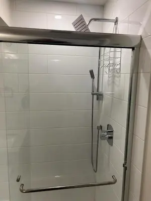 a shower in a bathroom with a glass door at Spacious one Bedroom Suite Right in Downtown ! in Maple Ridge District Municipality
