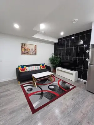 a living room with a couch and a table at Haven Lodge, 2BR Brand New Basement Suite in Calgary
