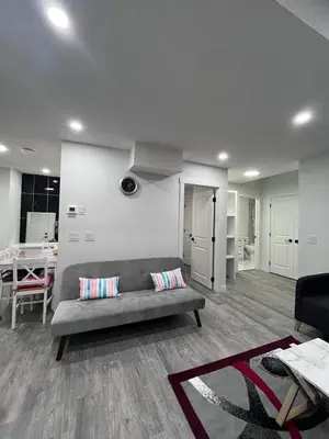 a living room with a couch and a table at Haven Lodge, 2BR Brand New Basement Suite in Calgary