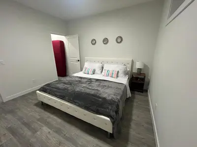 a bedroom with a large bed in a room at Haven Lodge, 2BR Brand New Basement Suite in Calgary