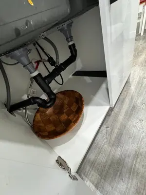 a wooden toilet sitting under a counter in a room at Haven Lodge, 2BR Brand New Basement Suite in Calgary