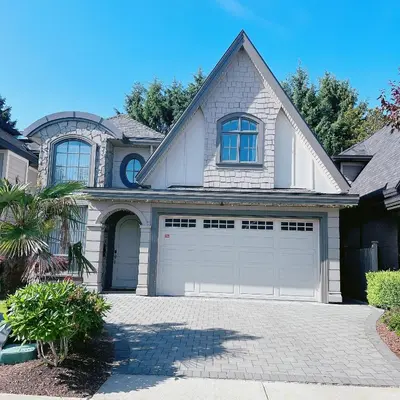 a white house with a garage at Cozy home in Richmond