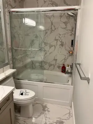 a bathroom with a shower and a toilet and a sink at Cozy home in Richmond