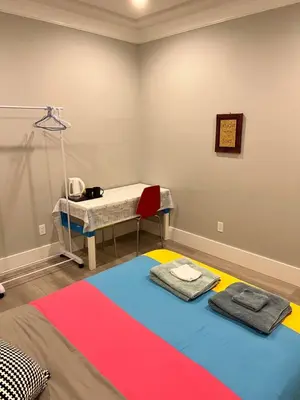 a room with a bed and a table with towels at Cozy home in Richmond