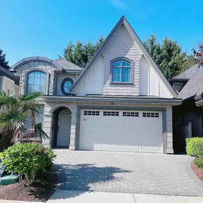 a house with two garage doors in a driveway at Cozy home in Richmond