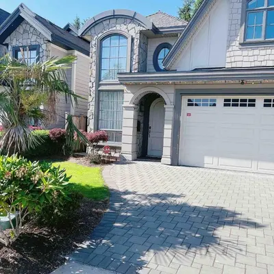 a house with a white garage and a driveway at Cozy home in Richmond