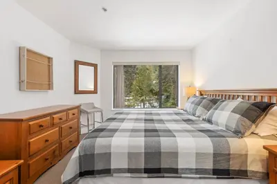 a bedroom with a bed and a window at Foxglove by Whistler Premier in Whistler