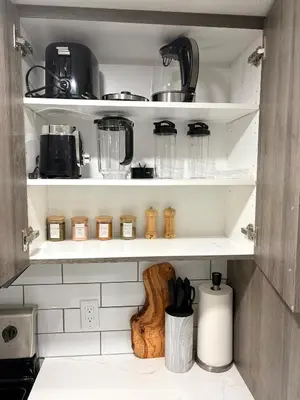 a kitchen pantry filled with lots of kitchen utensils at Coziest & Modern Basement Retreat East of Calgary in Chestermere