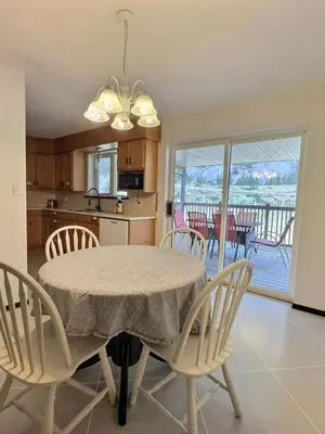 a kitchen and dining room with a table and chairs at Vineyard Home Casa De Herrera in Keremeos
