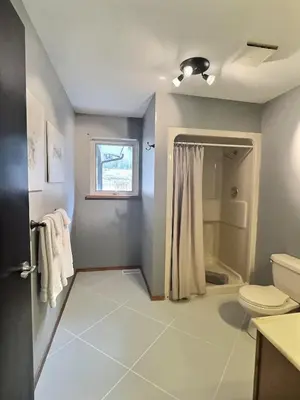 a bathroom with a toilet and a shower at Vineyard Home Casa De Herrera in Keremeos