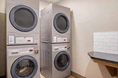 two washer and dryers in a laundry room at Canalta Cochrane in Cochrane