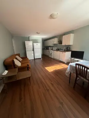 a living room with a couch and a kitchen at 2 bedroom Suite with private entrance in Langley