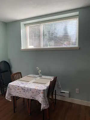 a table in a room with a window at 2 bedroom Suite with private entrance in Langley