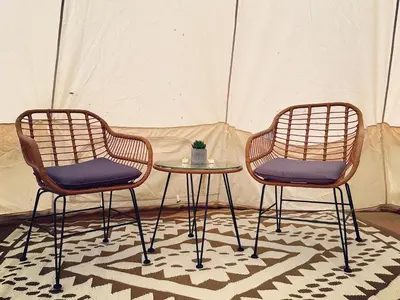 two chairs and a table in front of a tent at Everlong Acres Belle Tent in Owlseye