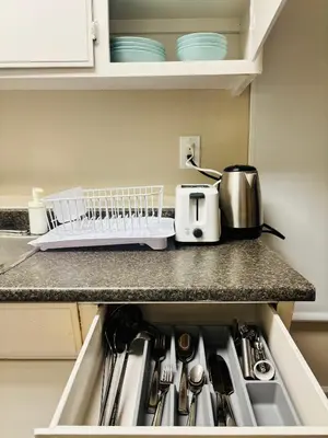 a kitchen counter with a sink and a toaster at Main Floor 1 Bedroom Suite with Parking in Calgary