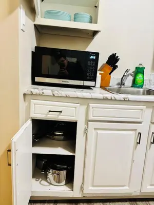 a microwave oven sitting on top of a kitchen counter at Upper Floor 1 Bedroom Suite with Parking in Calgary