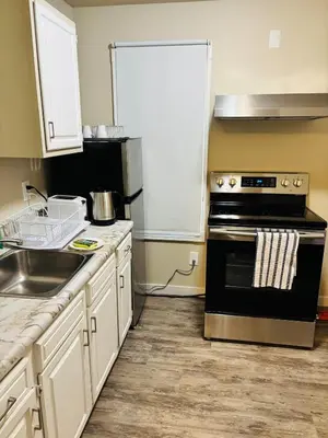 a kitchen with a stove and a sink at Upper Floor 1 Bedroom Suite with Parking in Calgary