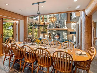 a dining room with a large wooden table and chairs at Hapala Chalet in Whistler