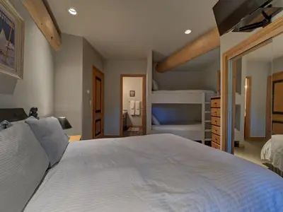 a bedroom with a large white bed in a room at Hapala Chalet in Whistler