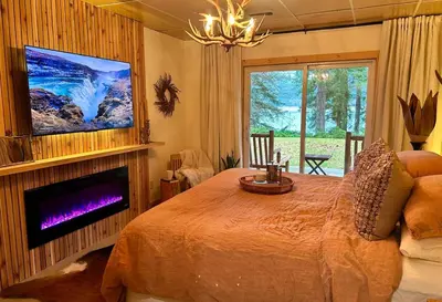 a bedroom with a large bed and a tv at Tea Time Lakeside in Fauquier