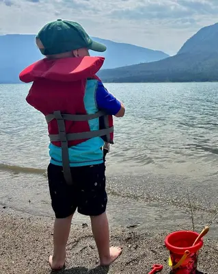 a young child standing on the shore of a lake at Tea Time Lakeside in Fauquier