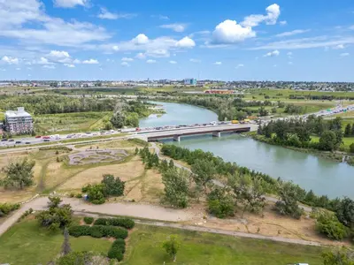an aerial view of a river with a bridge at Modern 3 Bedroom Suite Near Downtown & Stampede Grounds in Calgary
