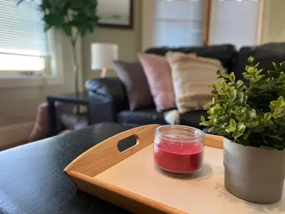 a wooden tray with a jar of red liquid on a table at Relaxing Mountain View Condo in Beautiful Radium in Radium Hot Springs