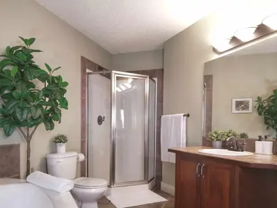 a bathroom with a shower and a toilet and a sink at Relaxing Mountain View Condo in Beautiful Radium in Radium Hot Springs