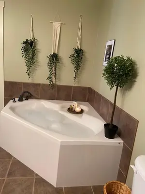 a white bath tub with potted plants in a bathroom at Relaxing Mountain View Condo in Beautiful Radium in Radium Hot Springs
